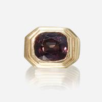 A color change alexandrite and eighteen karat gold ring