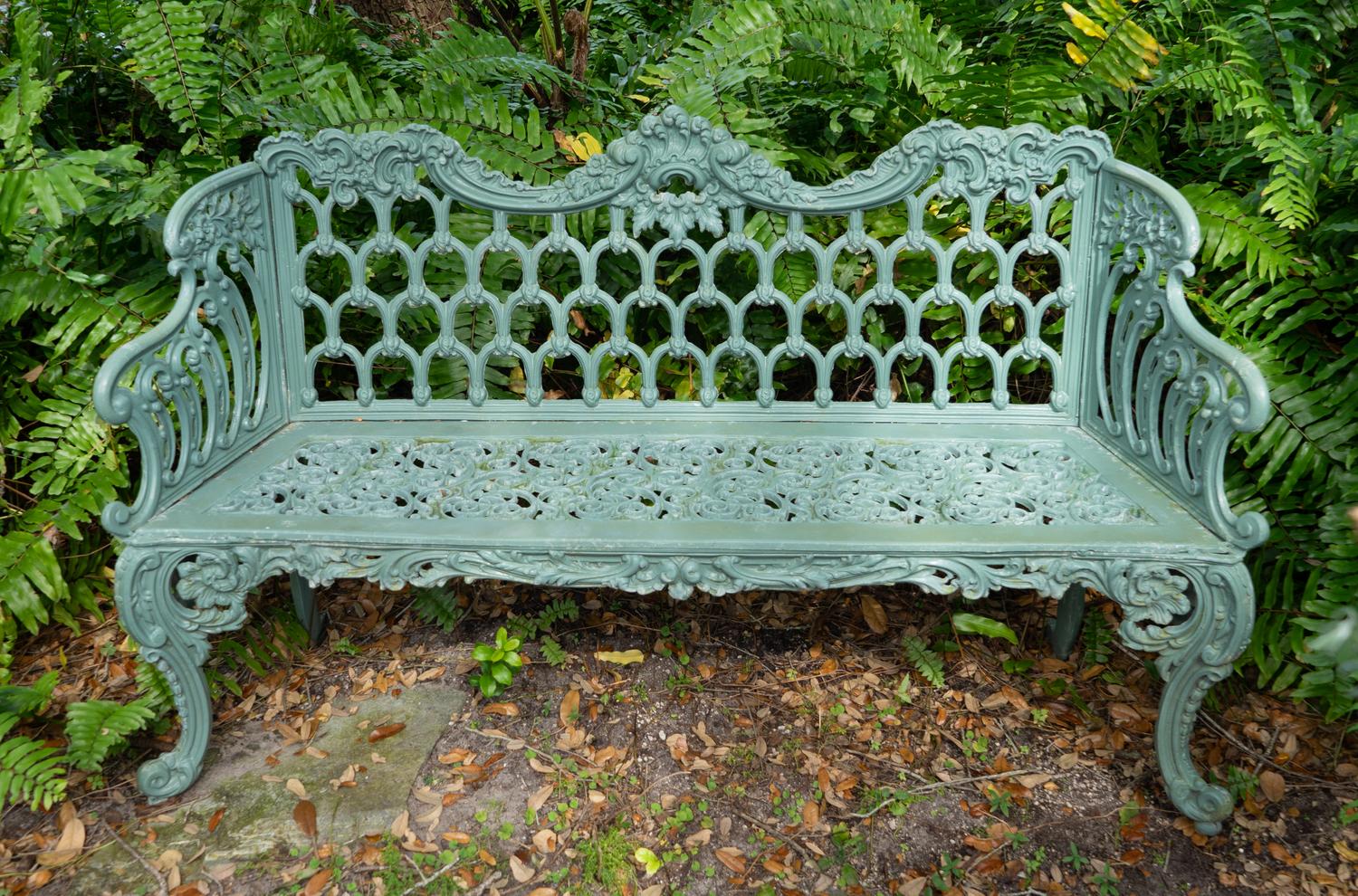 A Green-Painted Metal Garden Bench and Pair of Armchairs
