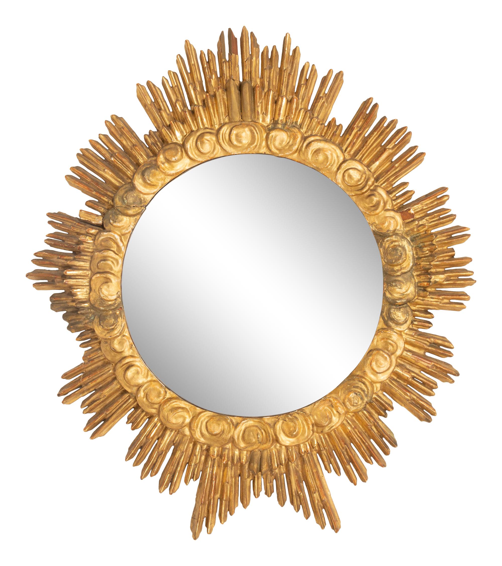 An Italian Carved Giltwood Sunburst and Cloud Framed Mirror