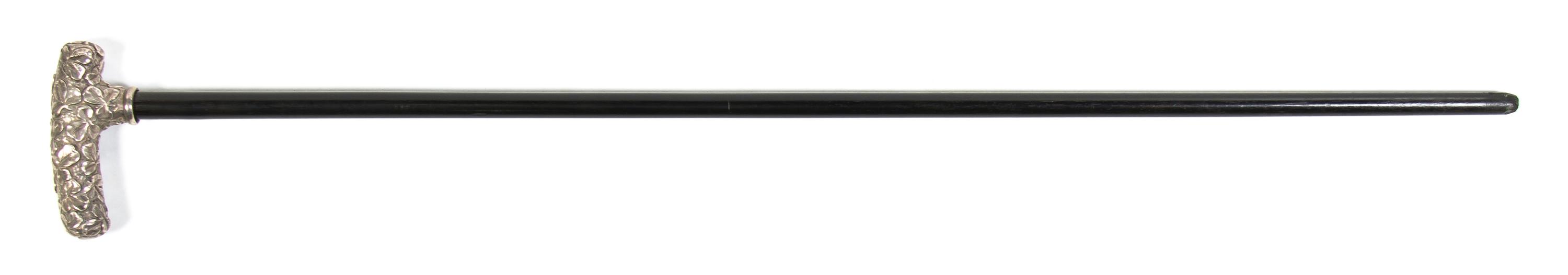 An American Sterling Silver Cane Handle, Height overall 32 1/2 x width of handle 4 3/8 inches.