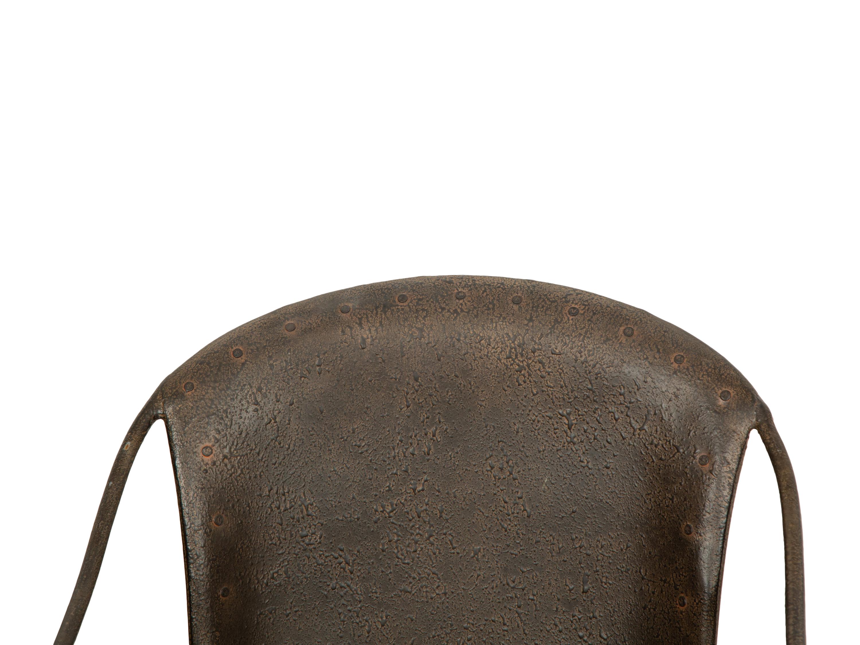 A Set of Seven Patinated Metal Dining Chairs