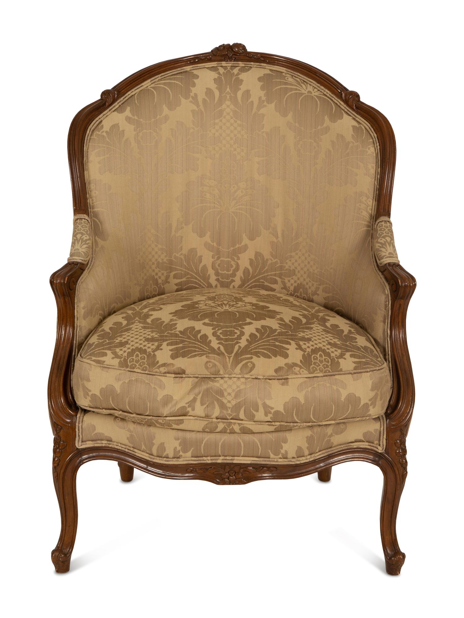 A Louis XV Style Carved Walnut Bergère