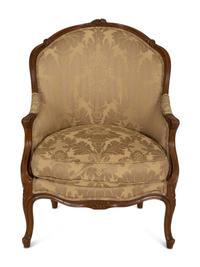 A Louis XV Style Carved Walnut Bergère