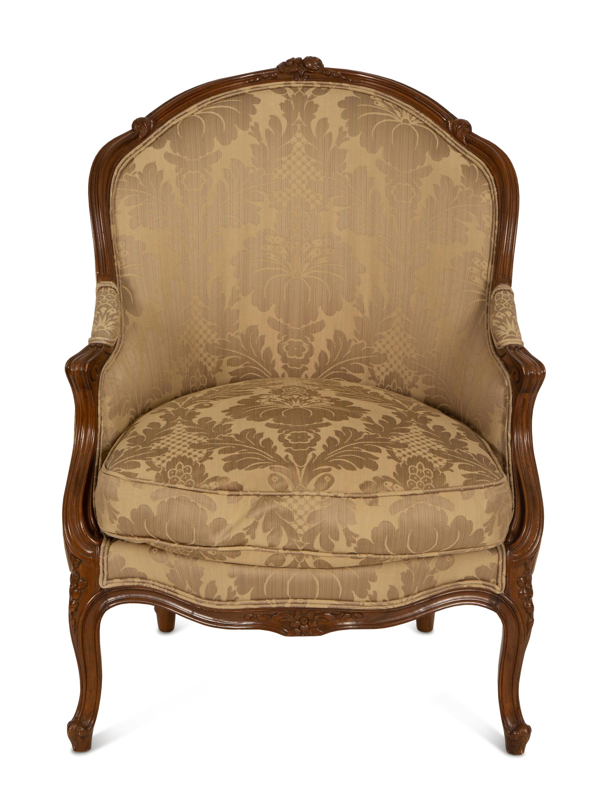 A Louis XV Style Carved Walnut Bergère