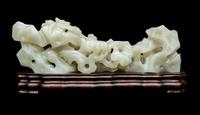 A Chinese Pale Celadon Jade ‘Lingzhi and Rockwork’ Brush Rest, 20th Century — 近代 青白玉靈芝筆架