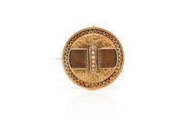 A Victorian Yellow Gold, Seed Pearl and Enamel Circle Brooch, 3.70 dwts.