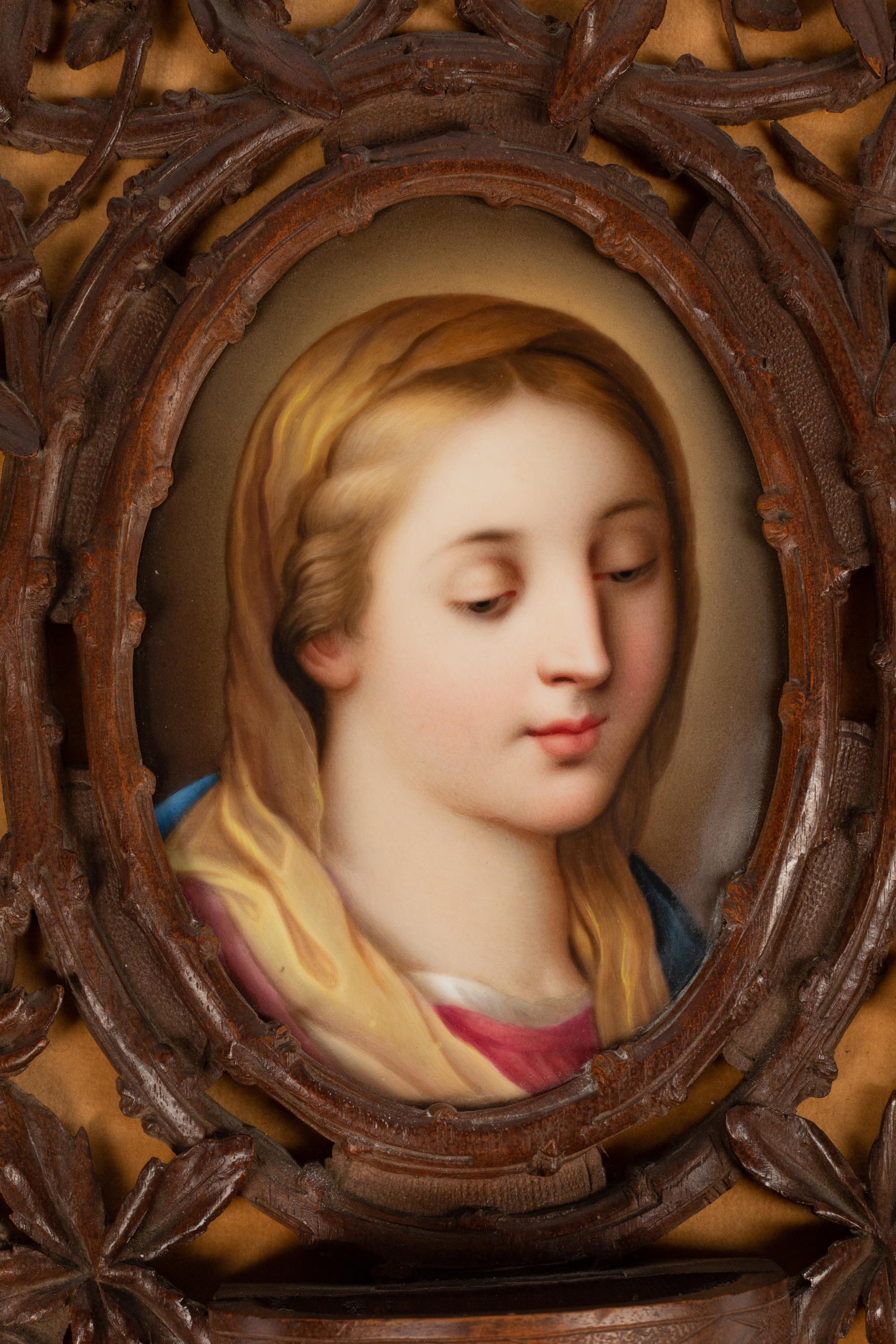 A Continental Porcelain Plaque in a Carved Oak Frame