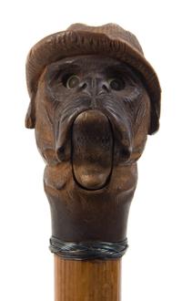 An American Carved Wood Glove Holder Cane, Length overall 35 1/2 inches.