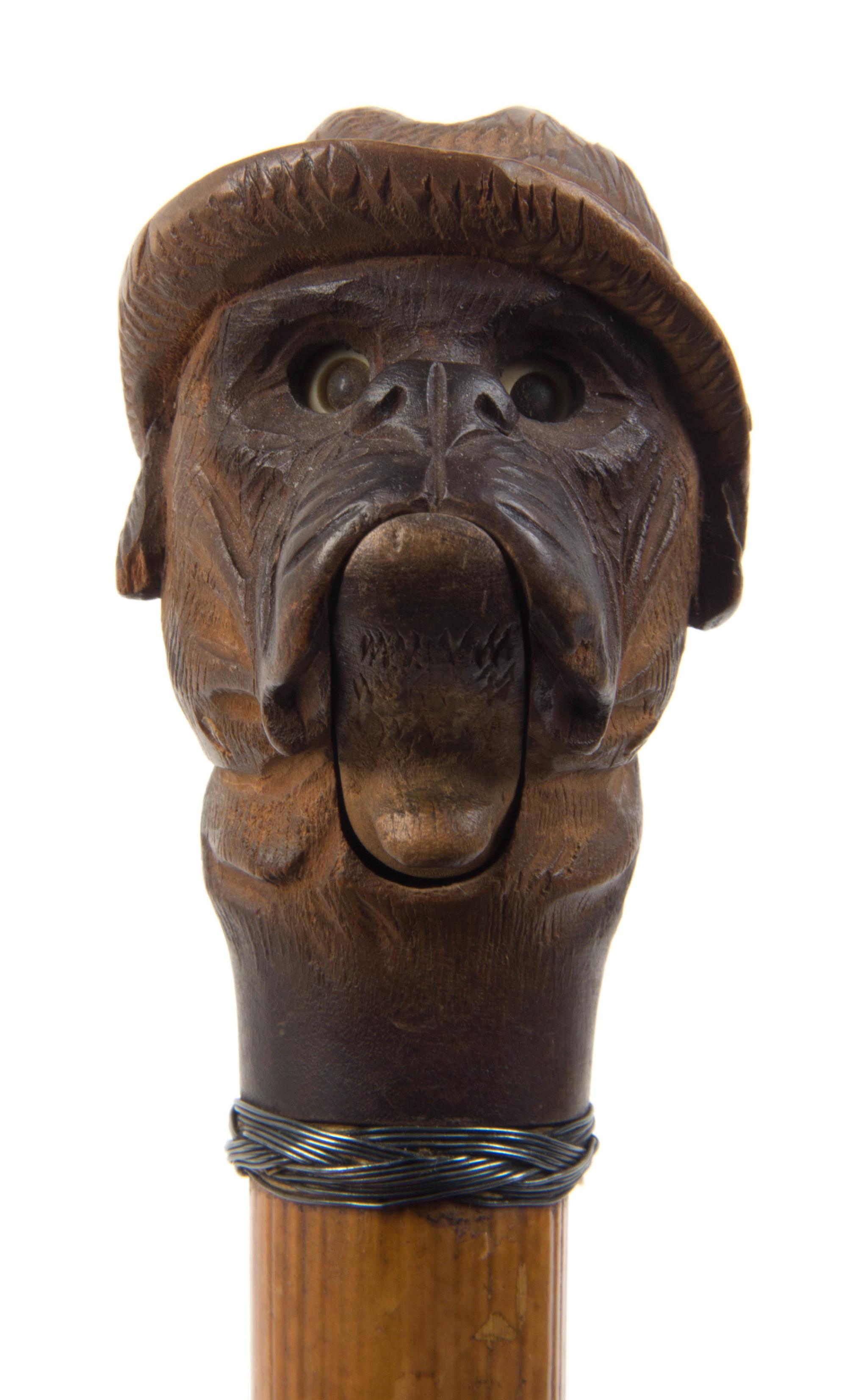 An American Carved Wood Glove Holder Cane, Length overall 35 1/2 inches.