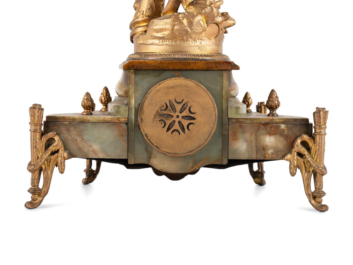 A French Metal and Onyx Clock Garniture with Figure after Francois Moreau (French, 1832-1927)