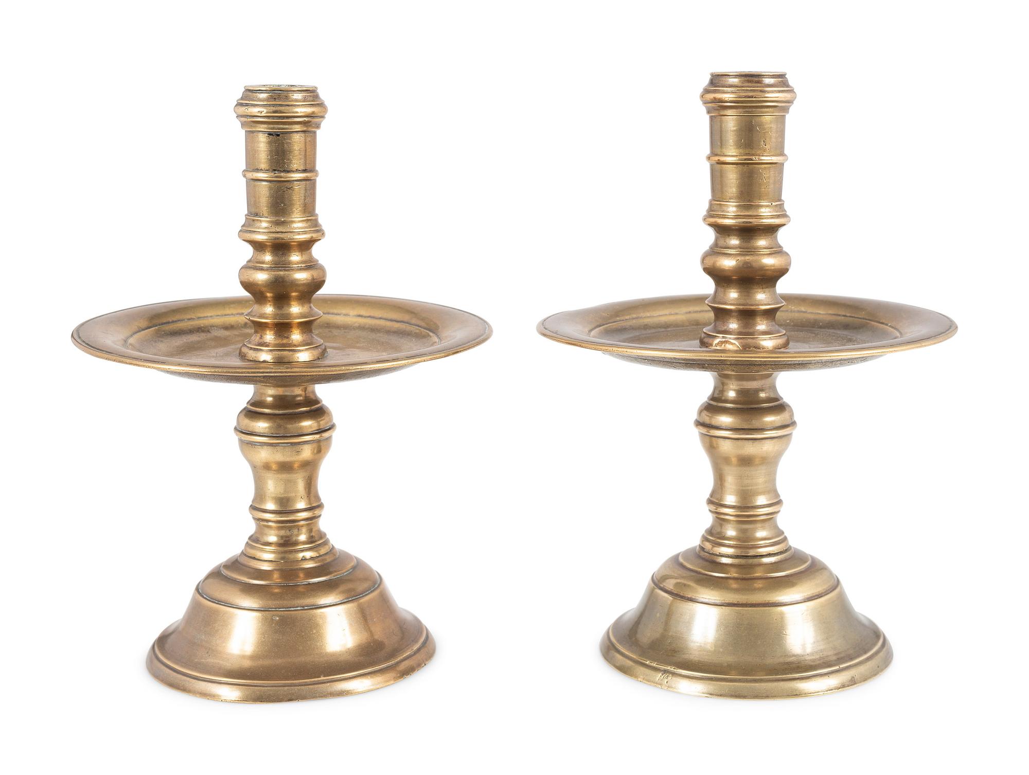 A Pair of Continental Brass Heemskirk Candlesticks