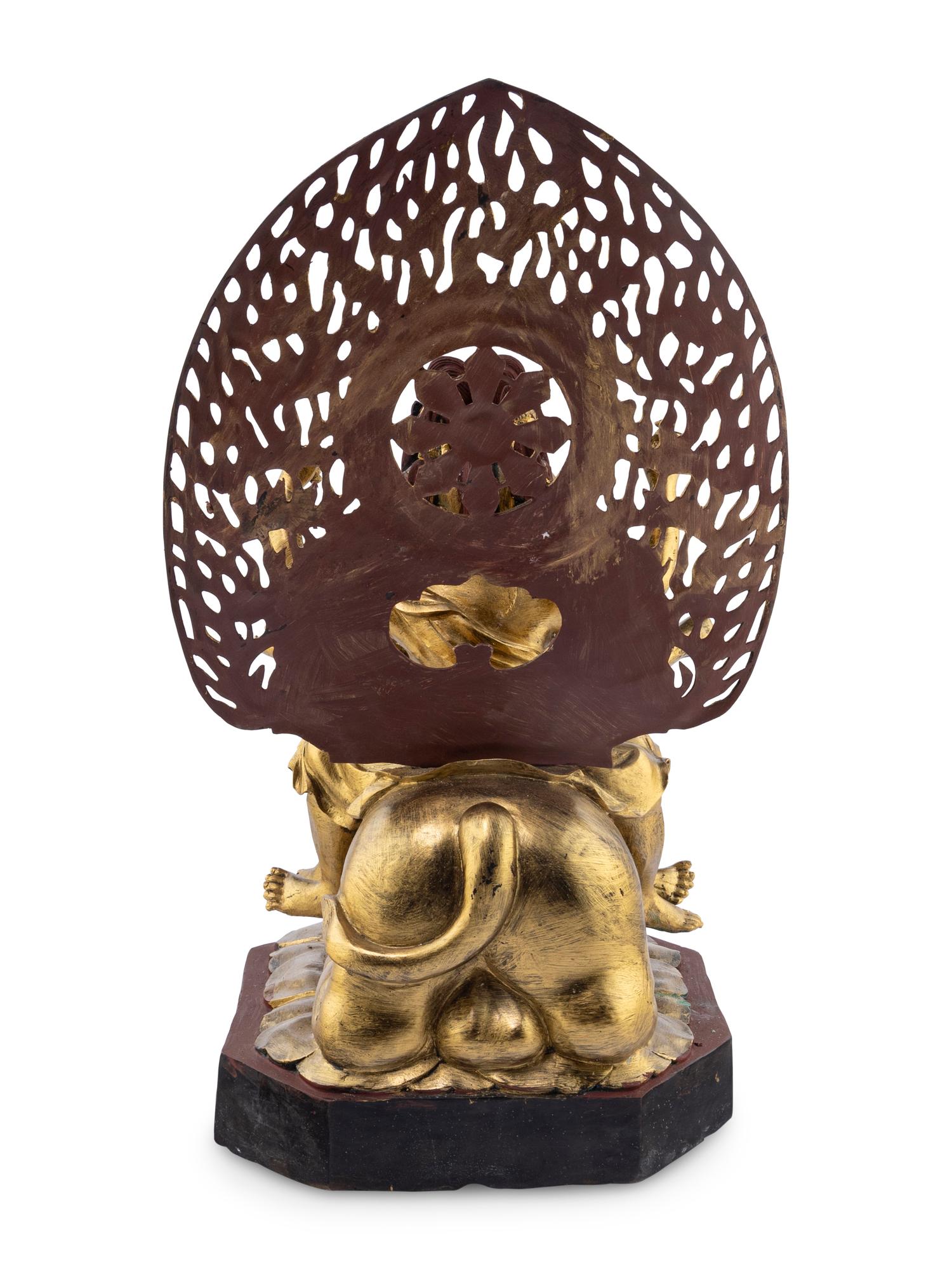 A Gilt and Red Lacquered Bronze Figure of a Multi-Armed Deity