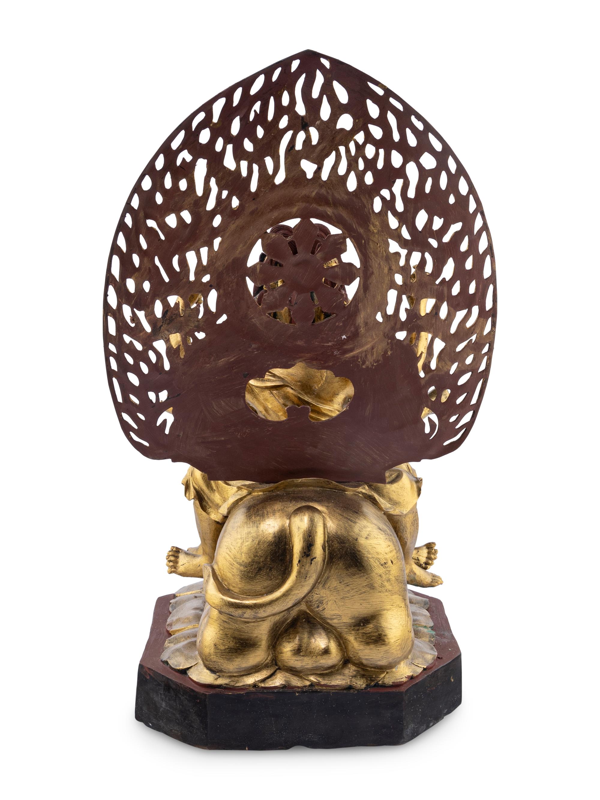 A Gilt and Red Lacquered Bronze Figure of a Multi-Armed Deity