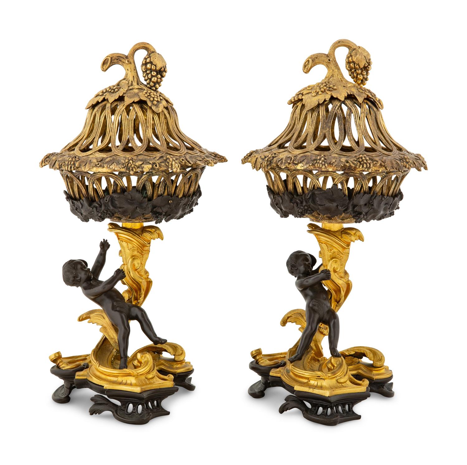 A Pair of Continental Rococo Style Parcel Gilt Bronze Figural Fruit Baskets