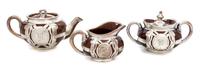 A Ceramic Silver Overlay Dimunitive Tea Service Width of teapot 6 1/2 inches.