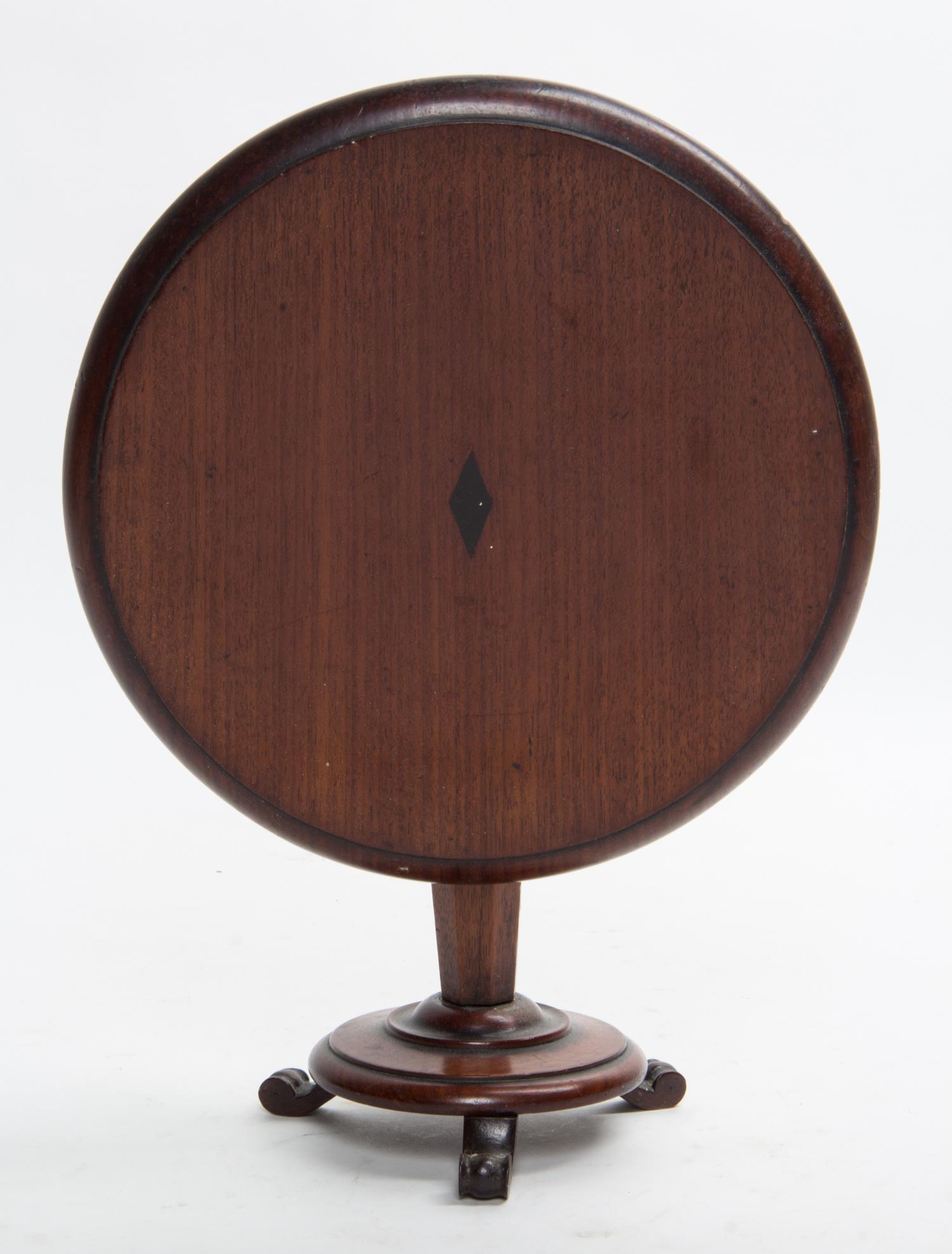 A Diminutive Regency Style Mahogany Tilt Top Table Height 8 1/4 x diameter 10 1/4 inches. — 20TH CENTURY