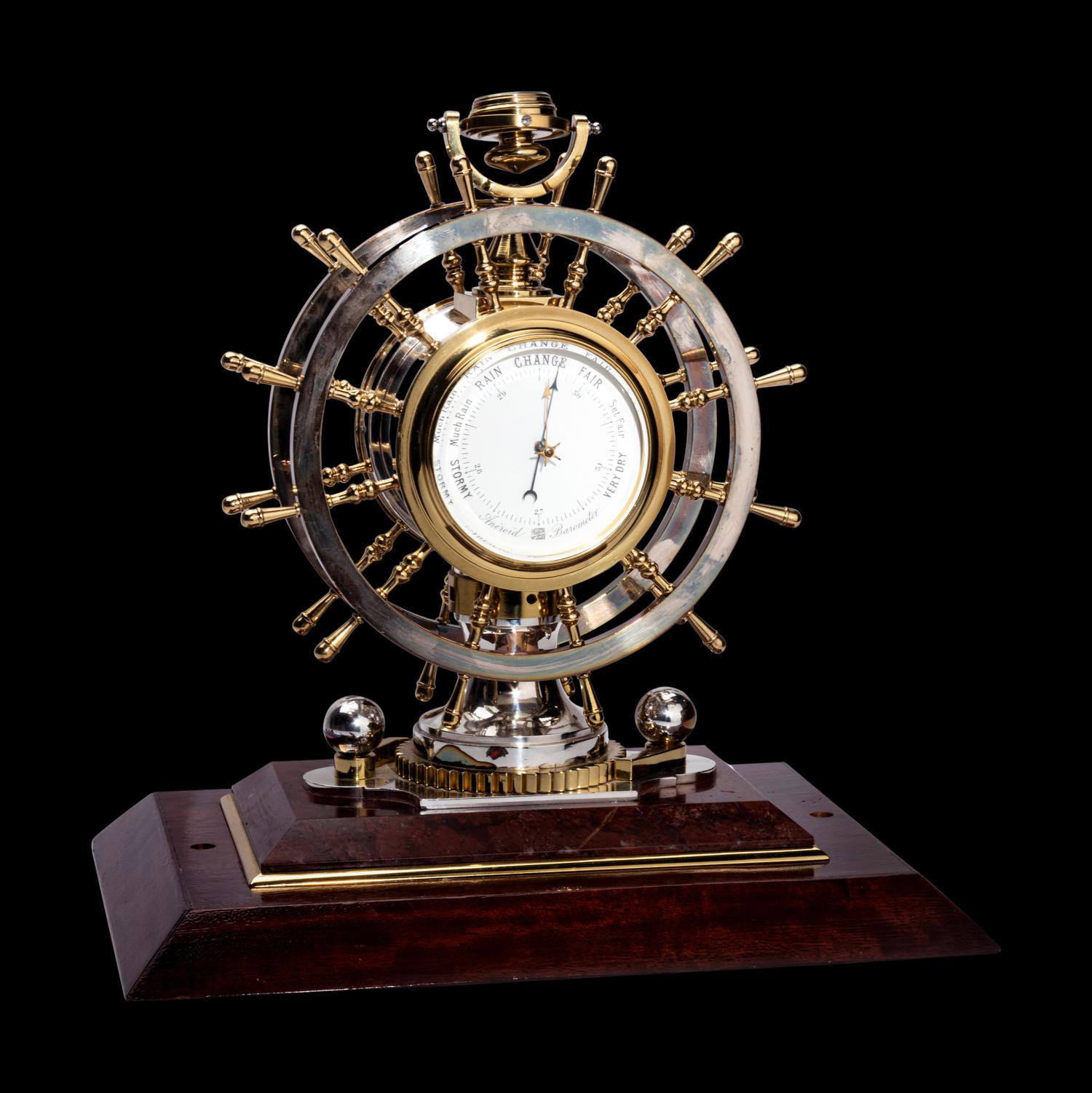 An English Steel and Brass Ship's Wheel Clock and Barometer, E&E Emanuel