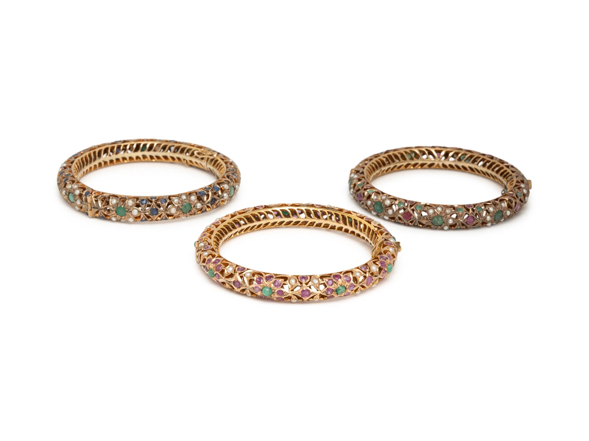 COLLECTION OF YELLOW GOLD AND LOW KARAT GOLD MULTIGEM BANGLE BRACELETS