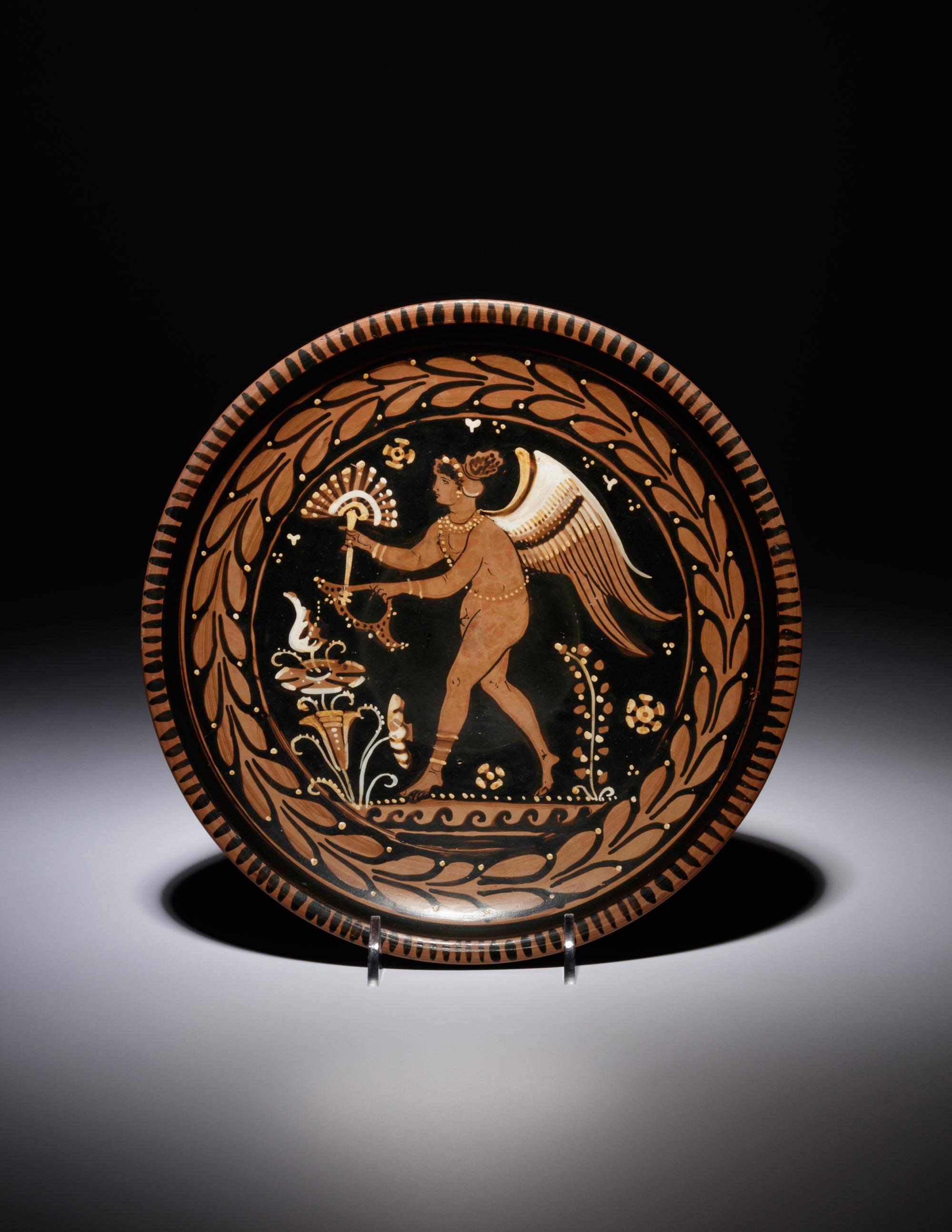 An Apulian Red-Figured Plate with Striding Eros