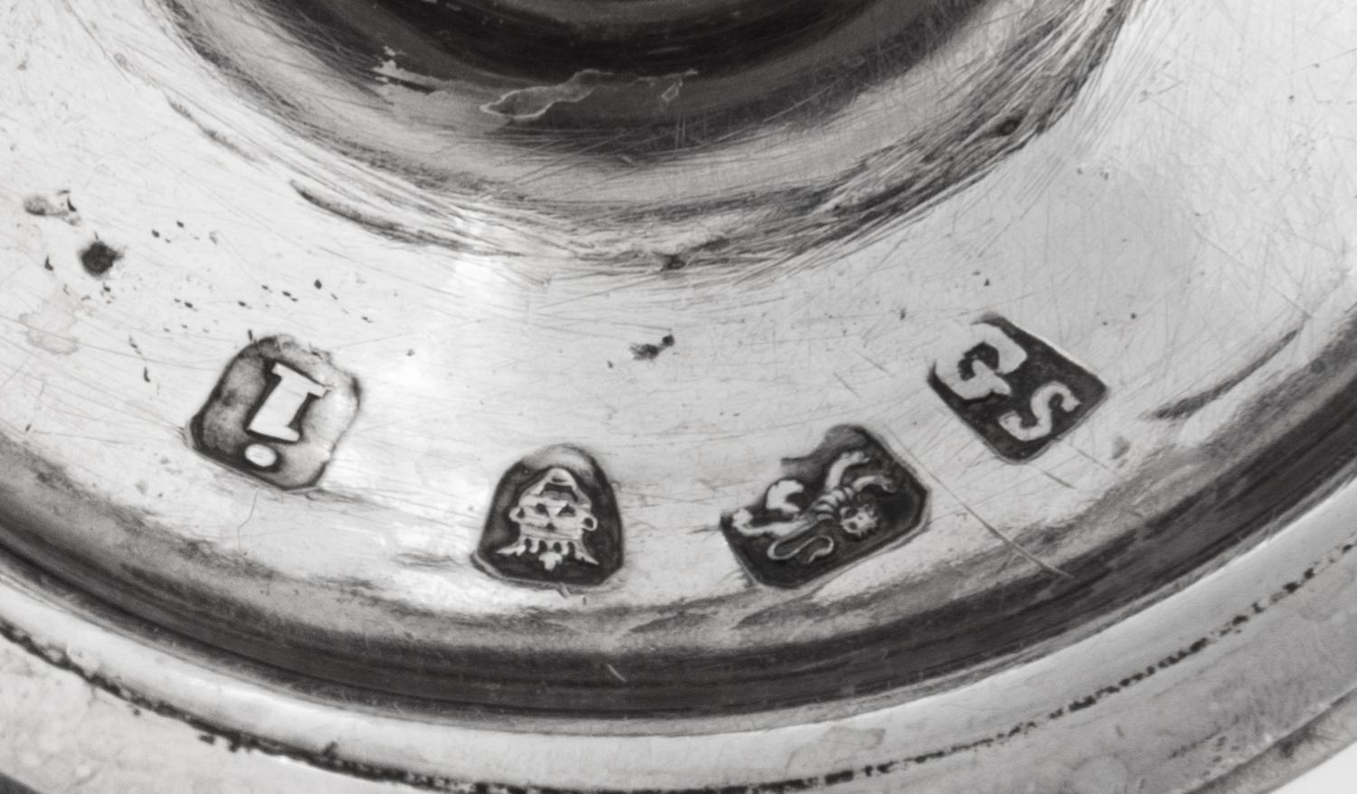 A Near Pair of George III Silver Casters