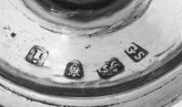 A Near Pair of George III Silver Casters