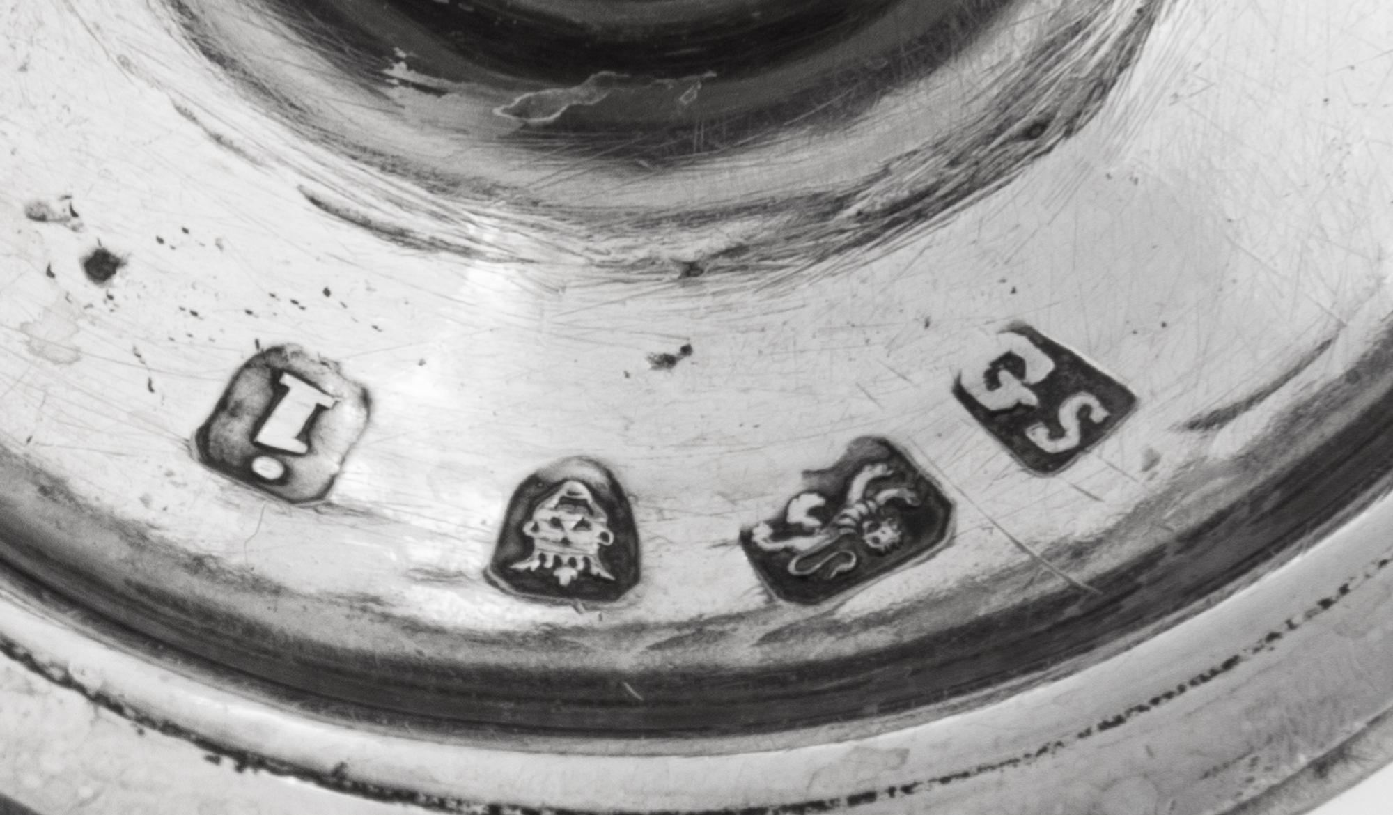 A Near Pair of George III Silver Casters