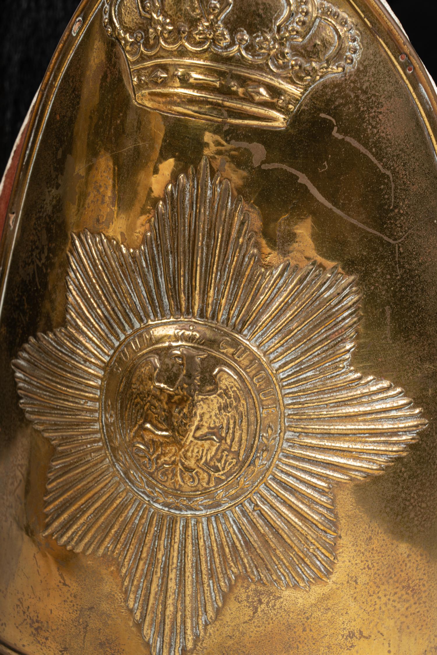A Collection of Twenty-One Military Parade Helmets, Hats and Masks