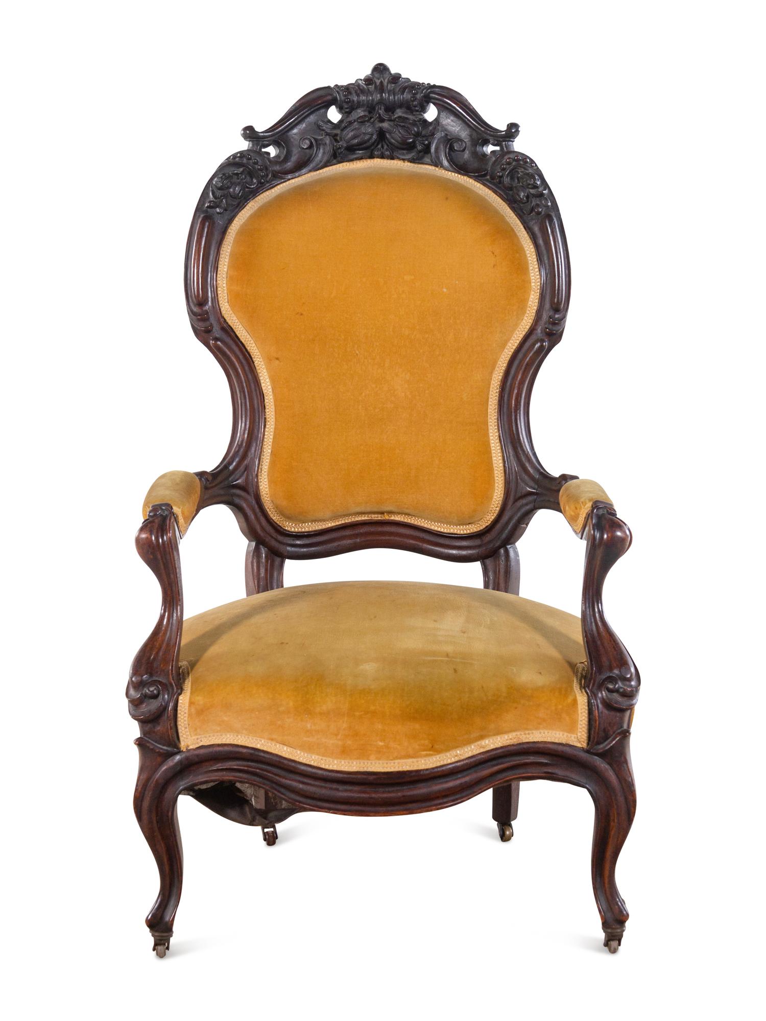 A Victorian Rococo Revival Carved Walnut Armchair