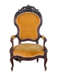 A Victorian Rococo Revival Carved Walnut Armchair