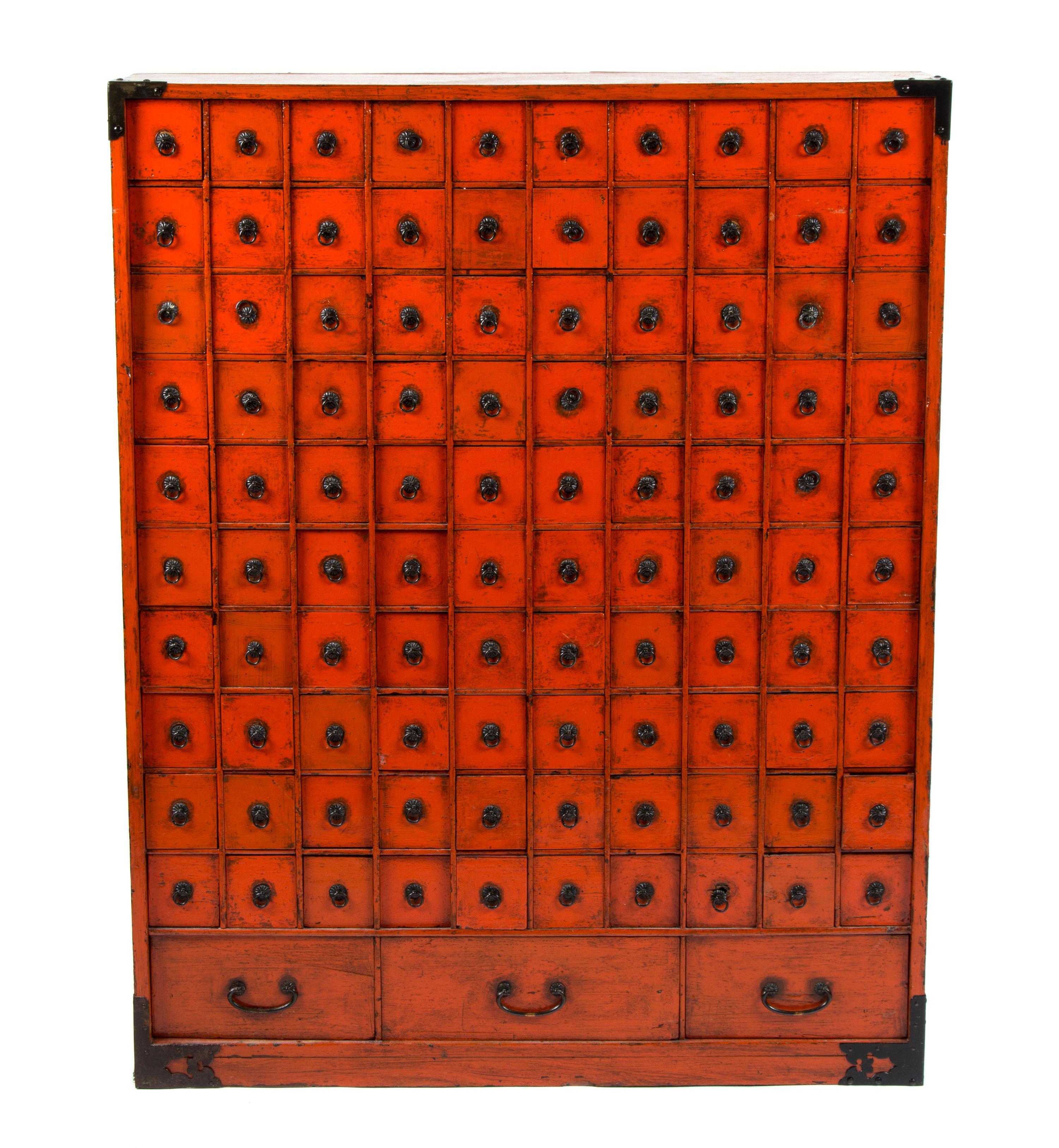 A Chinese Export Red Painted Apothecary Chest Height 37 1/2 x width 29 1/2 x depth 7 1/2 inches.