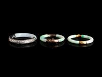 Three Chinese Silver and 14K Yellow Gold Jadeite Bangles