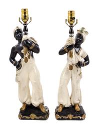 A Pair of Continental Parcel Gilt Porcelain Figural Lamps Height 18 inches.