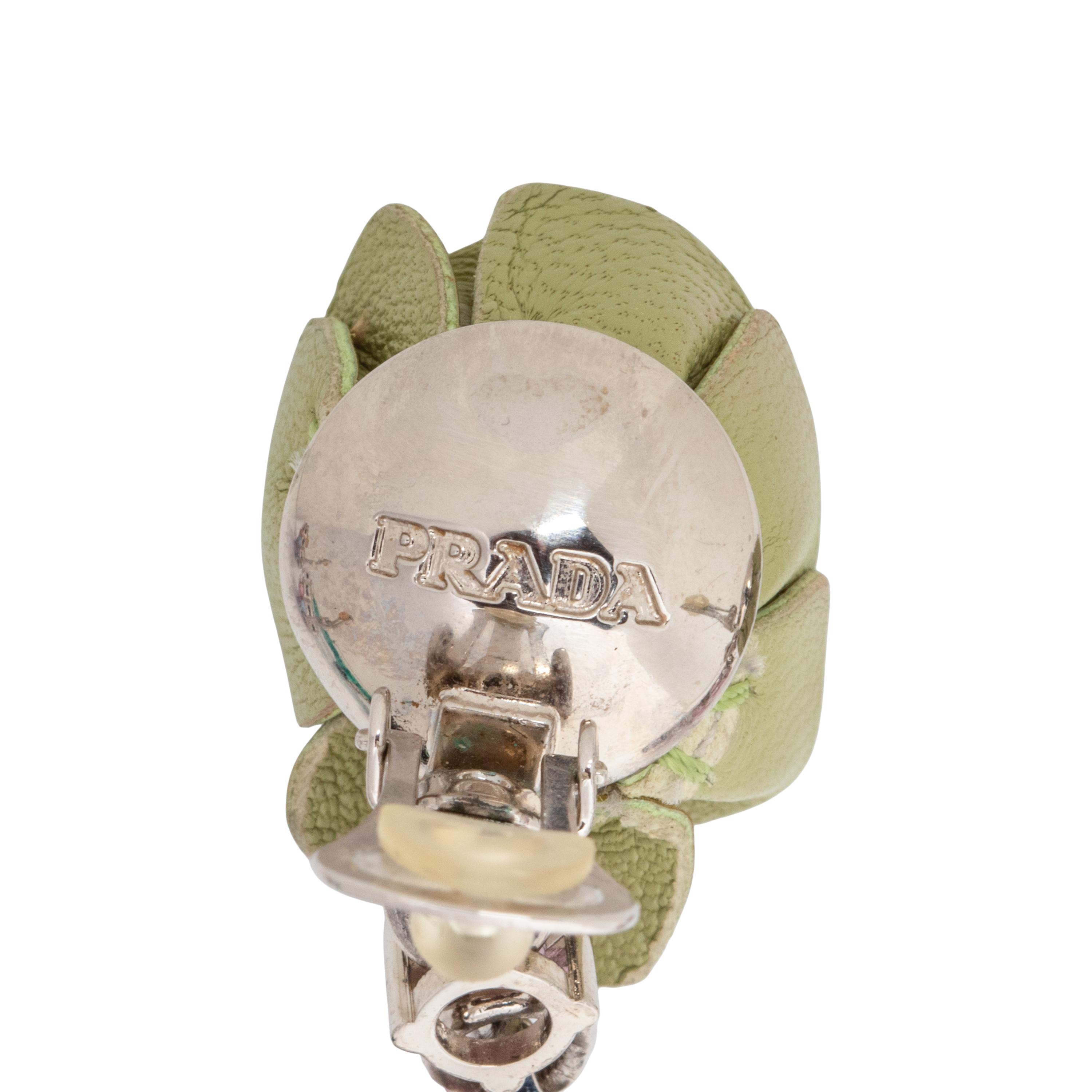 PRADA & MIU MIU, THREE BROOCHES & TWO PAIRS OF EAR CLIPS