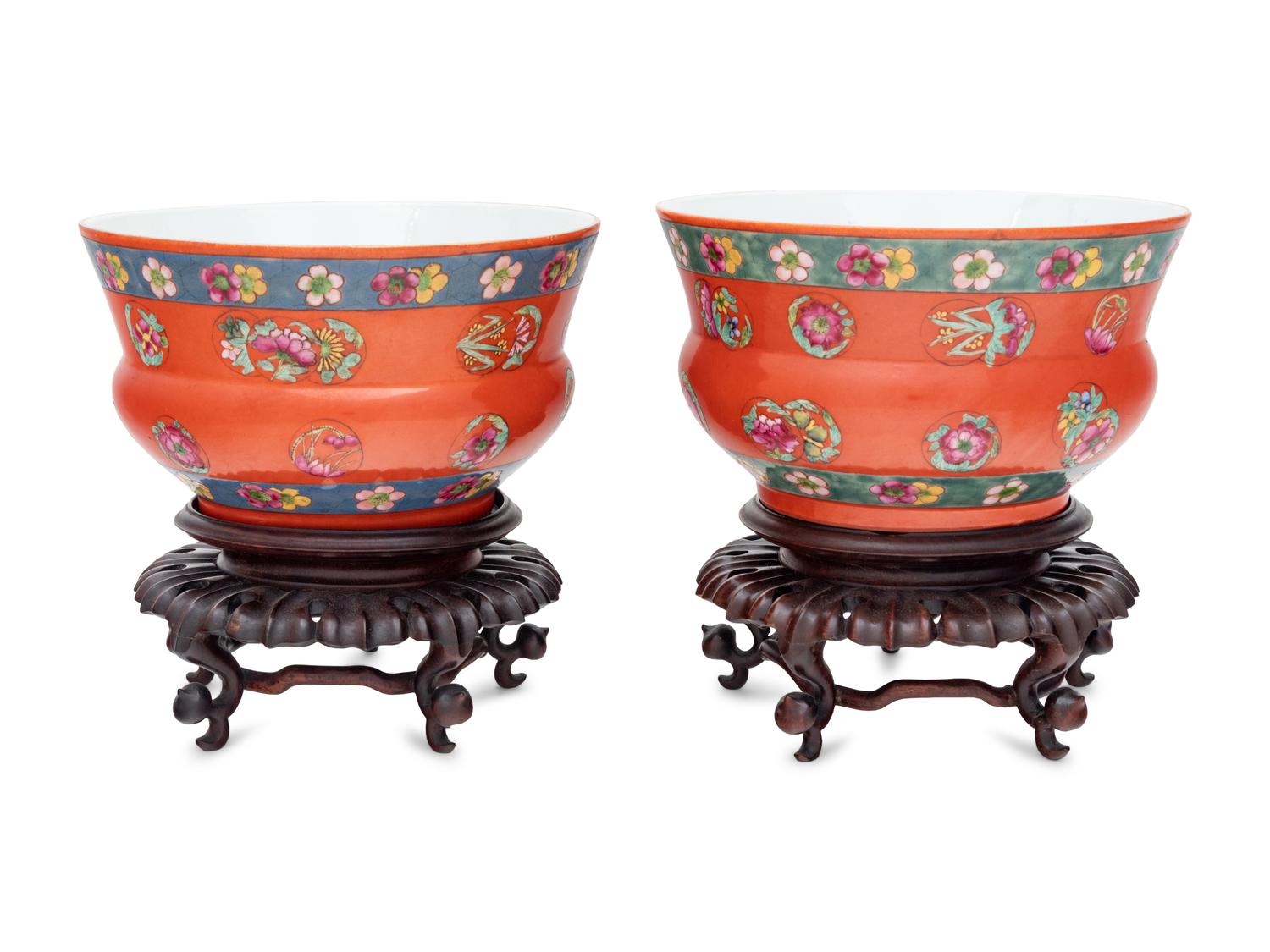 A Pair of Chinese Coral Red Ground Porcelain Cache Pots with Wood Stands