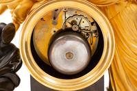 An Empire Gilt and Patinated Bronze Figural Mantel Clock