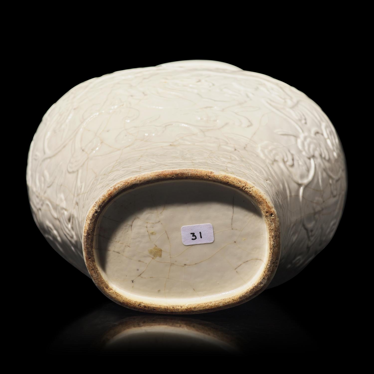 A Chinese White Glazed Soft Paste Molded 'Dragons and Lingzhi' Vase, 18th Century 清中期 白釉模印漿胎靈芝螭龍紋瓶