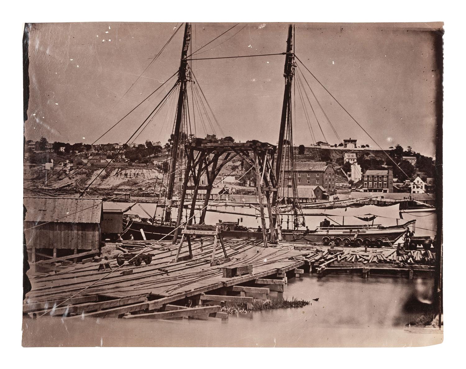 [CIVIL WAR]. Possibly by John REEKIE (active 1860s), or Alexander GARDNER (1821-1882), photographers. Wharf, South Side of James River, Opposite Richmond, Virginia . Ca 1865.