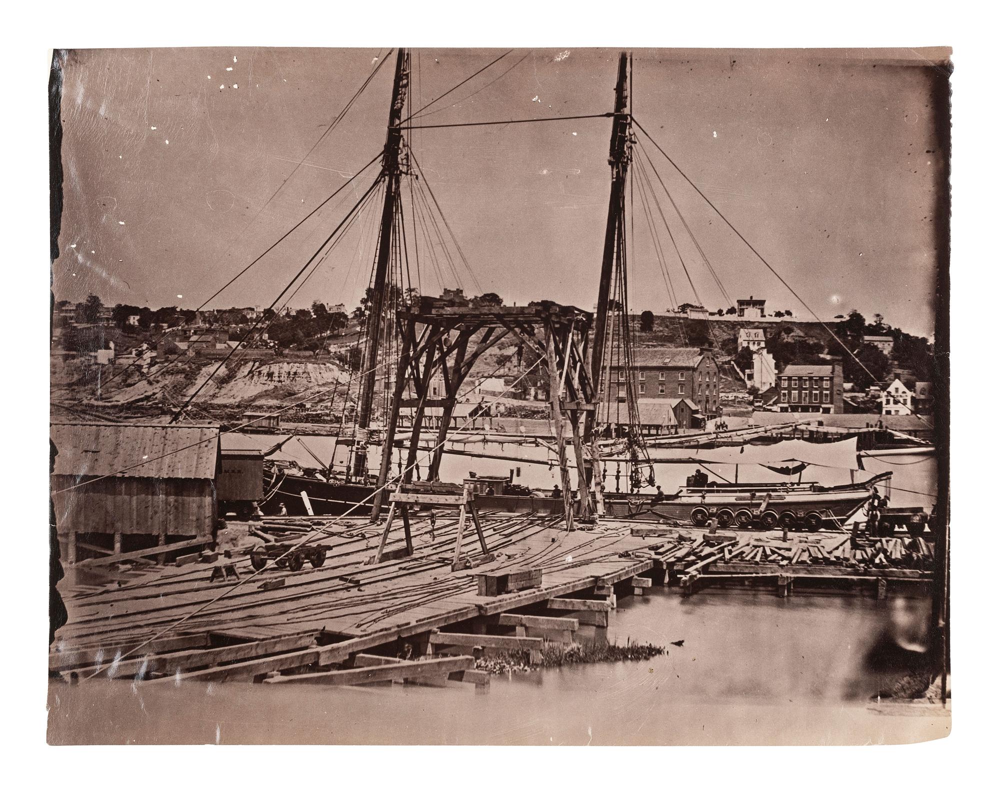 [CIVIL WAR]. Possibly by John REEKIE (active 1860s), or Alexander GARDNER (1821-1882), photographers. Wharf, South Side of James River, Opposite Richmond, Virginia . Ca 1865.