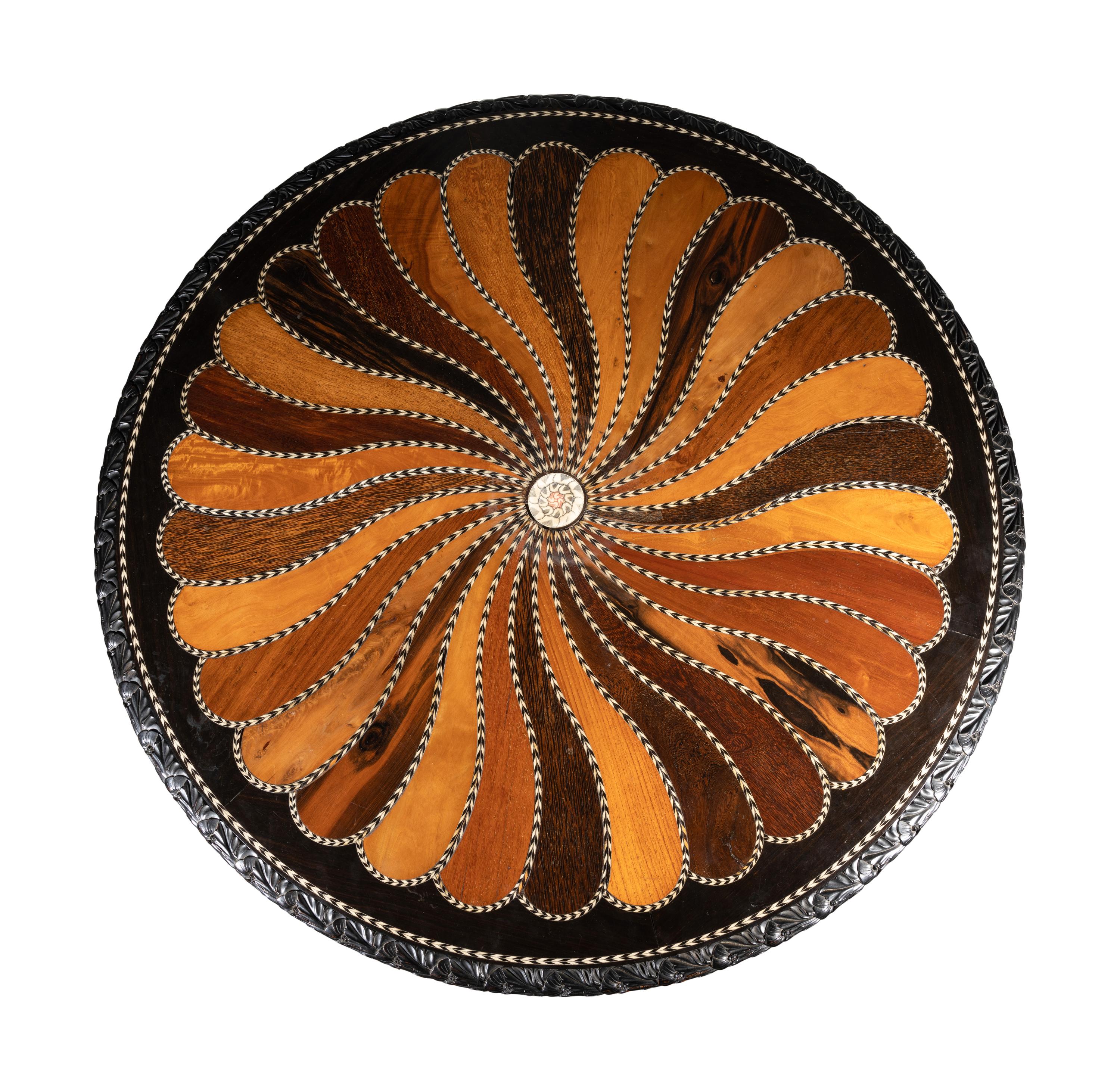 An Anglo-Colonial Carved and Specimen Woods Inlaid Tilt-Top Breakfast Table