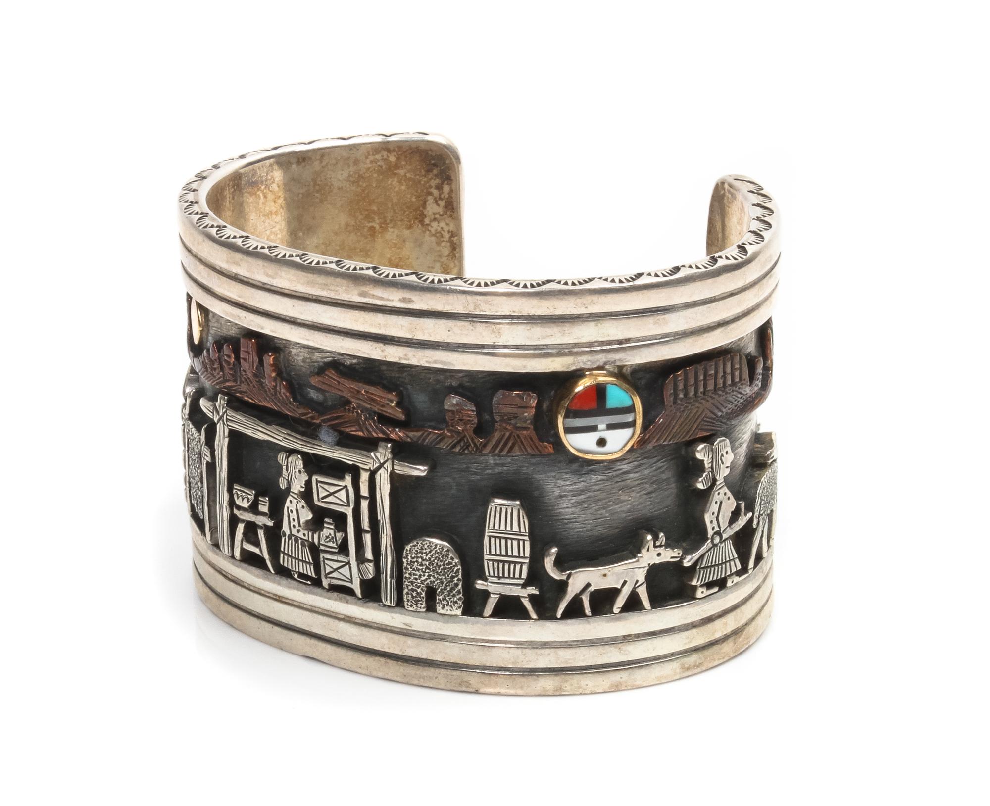 A Navajo Silver and 14 Karat Yellow Gold Storyteller Bracelet, Clarence Lee Length 4 3/4 x opening 1 1/8 x width 1 1/2 inches.