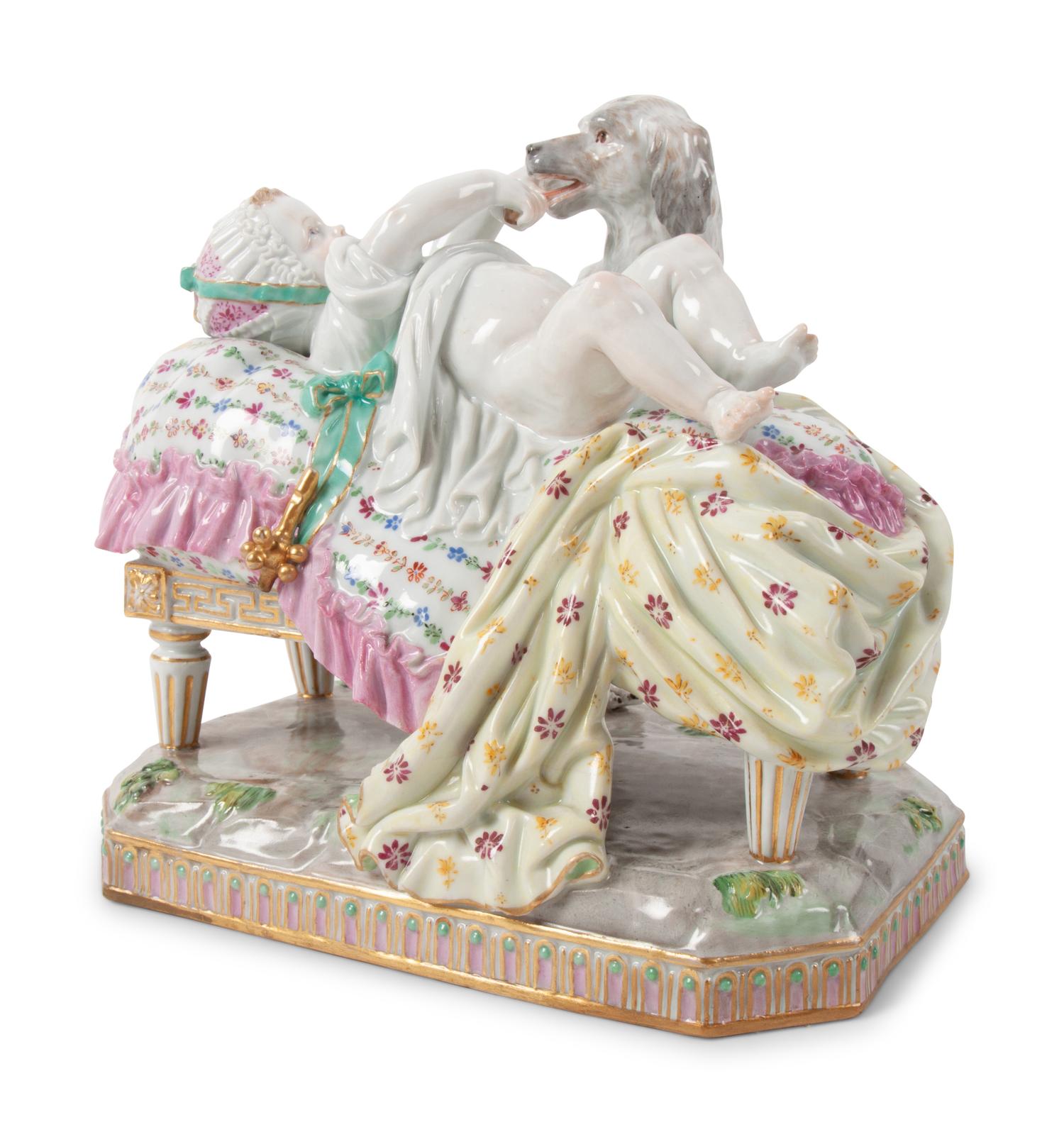 A Meissen Porcelain Figural Group of a Child in Bed with Dog