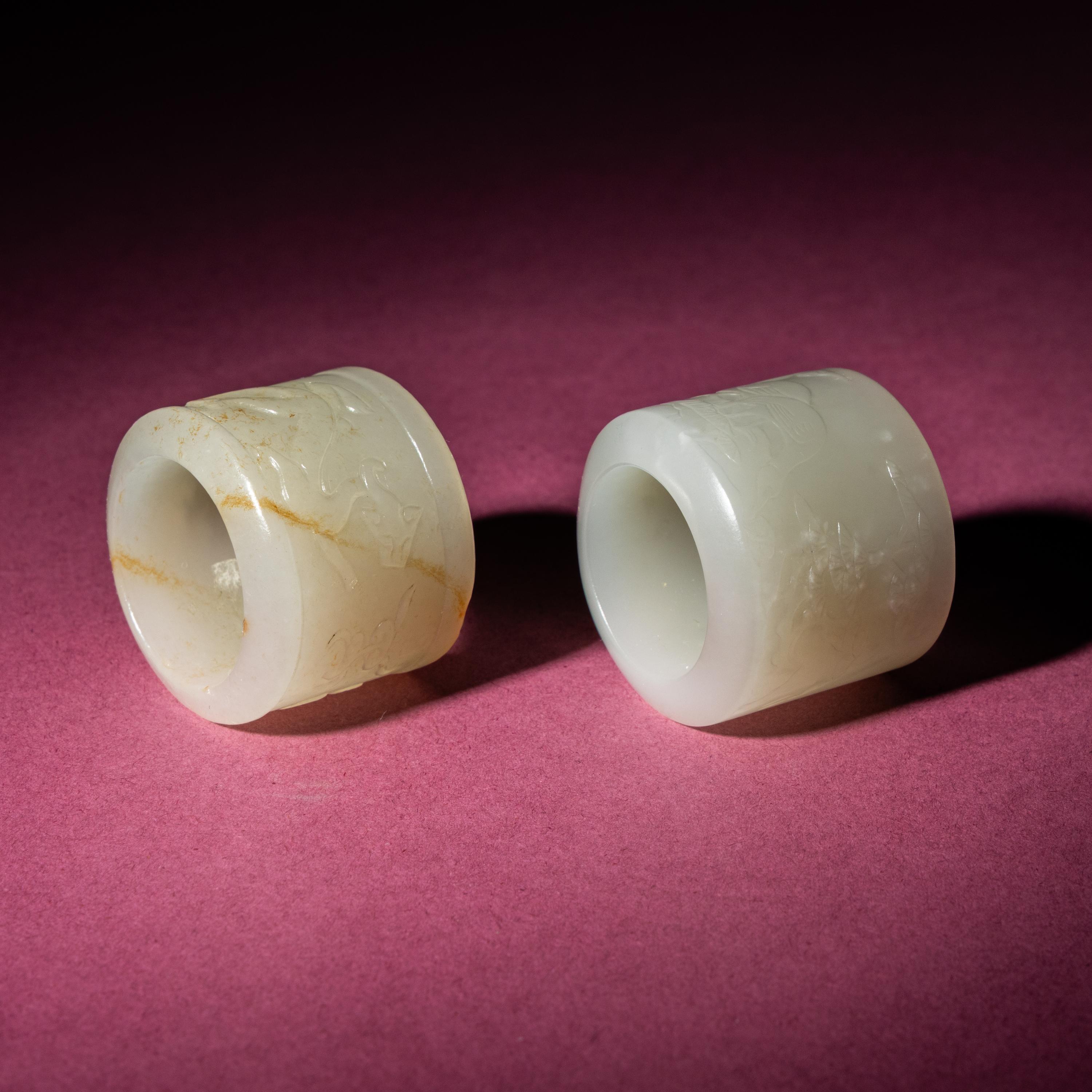 Two Chinese White Jade 'Animal' Archer's Rings, 18th Century — 清中期 白玉刻動物紋扳指兩枚