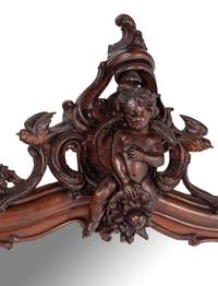 An Italian Rococo Revival Carved Walnut Mirror