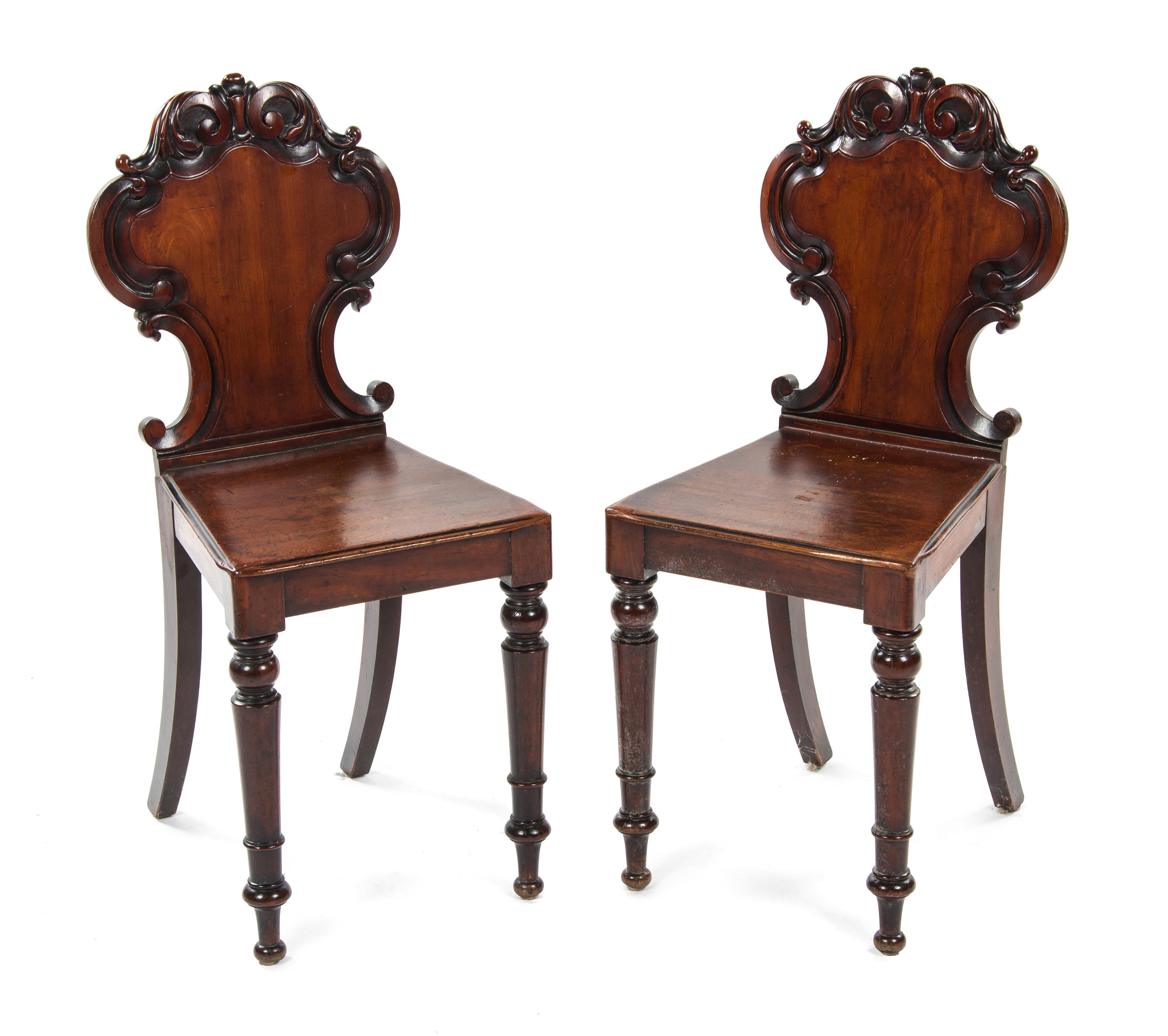 A Pair of Victorian Mahogany Hall Chairs, Height 34 1/4 inches.