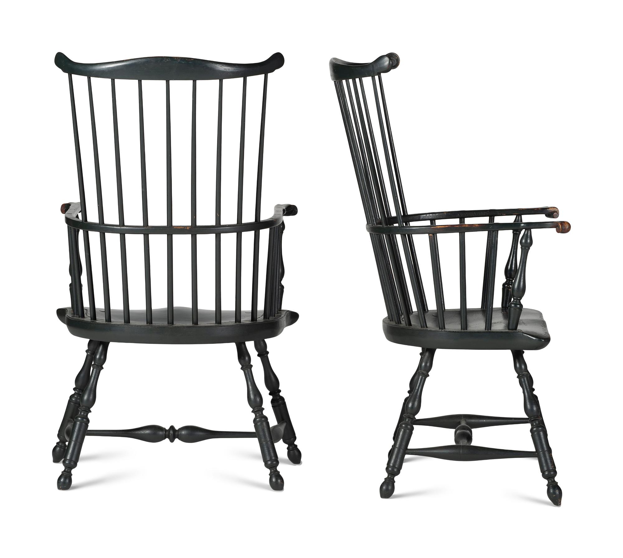 A Pair of Various Wood Black Painted Volute and Knuckle Carved Comb-Back Windsor Armchairs