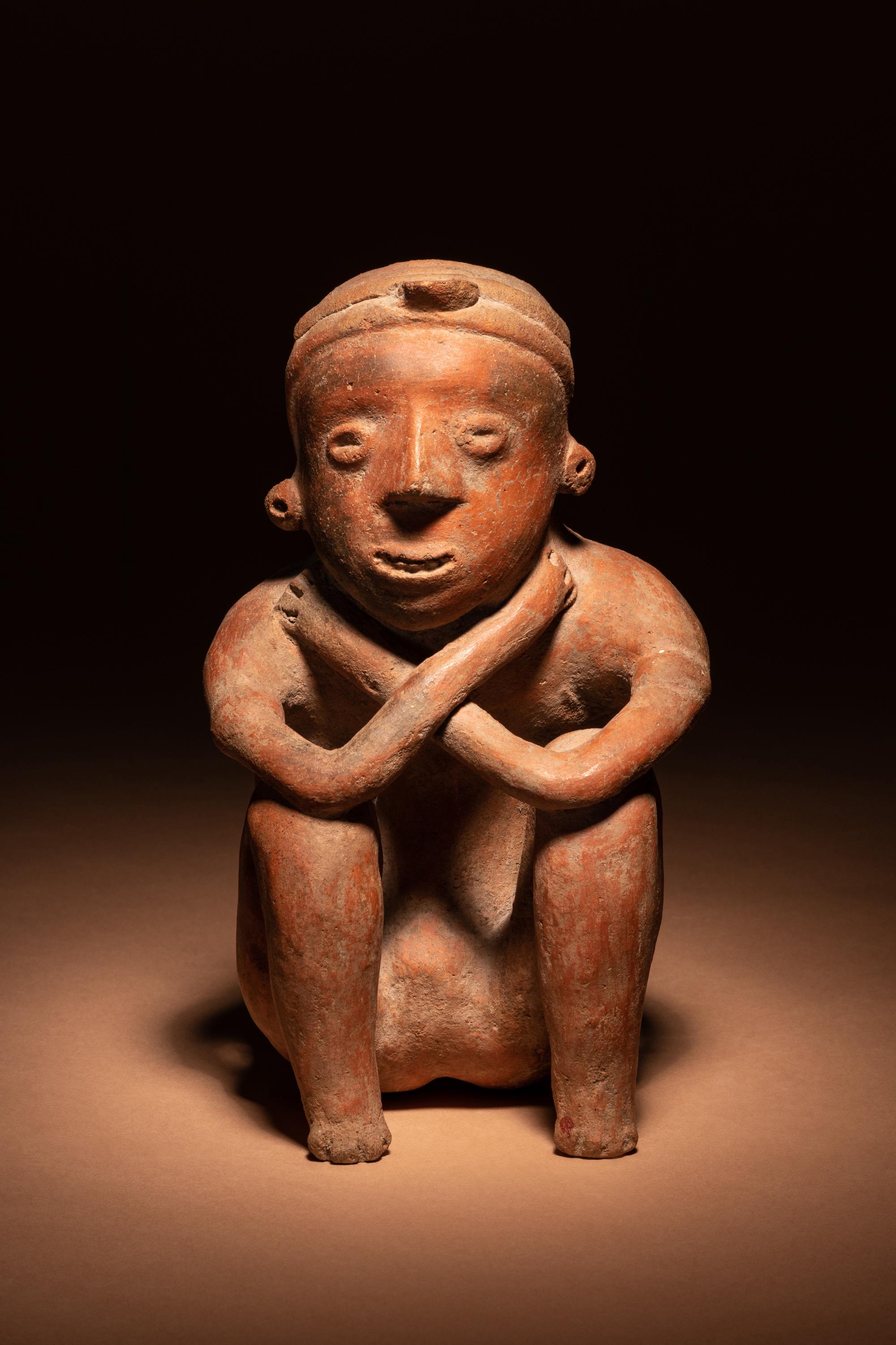 A Colima Terracotta Squatting Figure