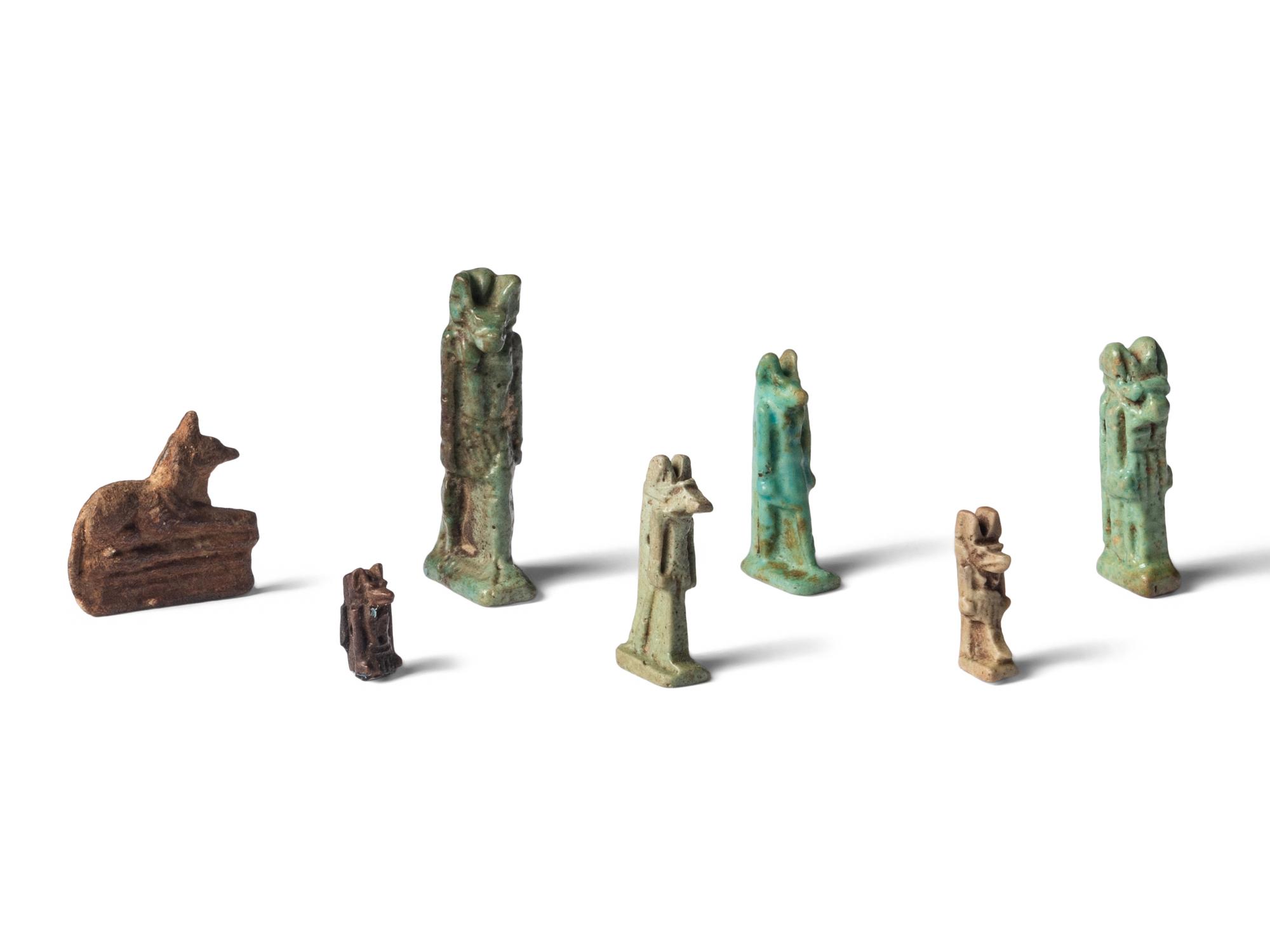Seven Egyptian Faience and Stone Anubis Amulets