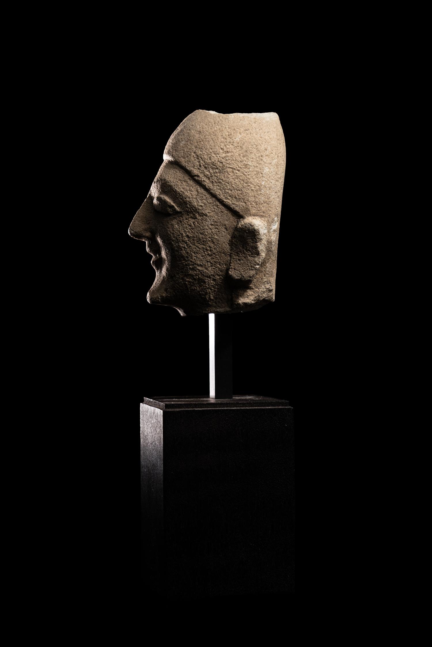 A Cypriot Limestone Head of a Man Wearing a Helmet