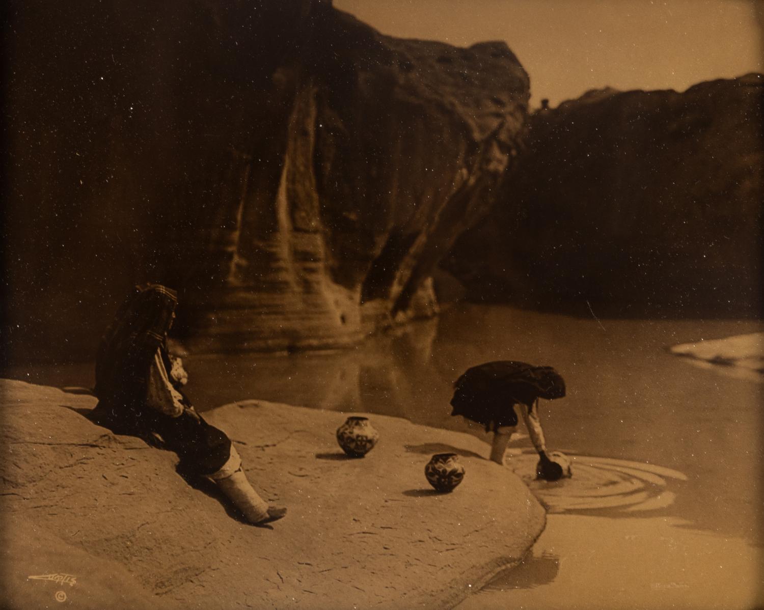 CURTIS, Edward S. (1868-1952), photographer. At the Old Well in Acoma .