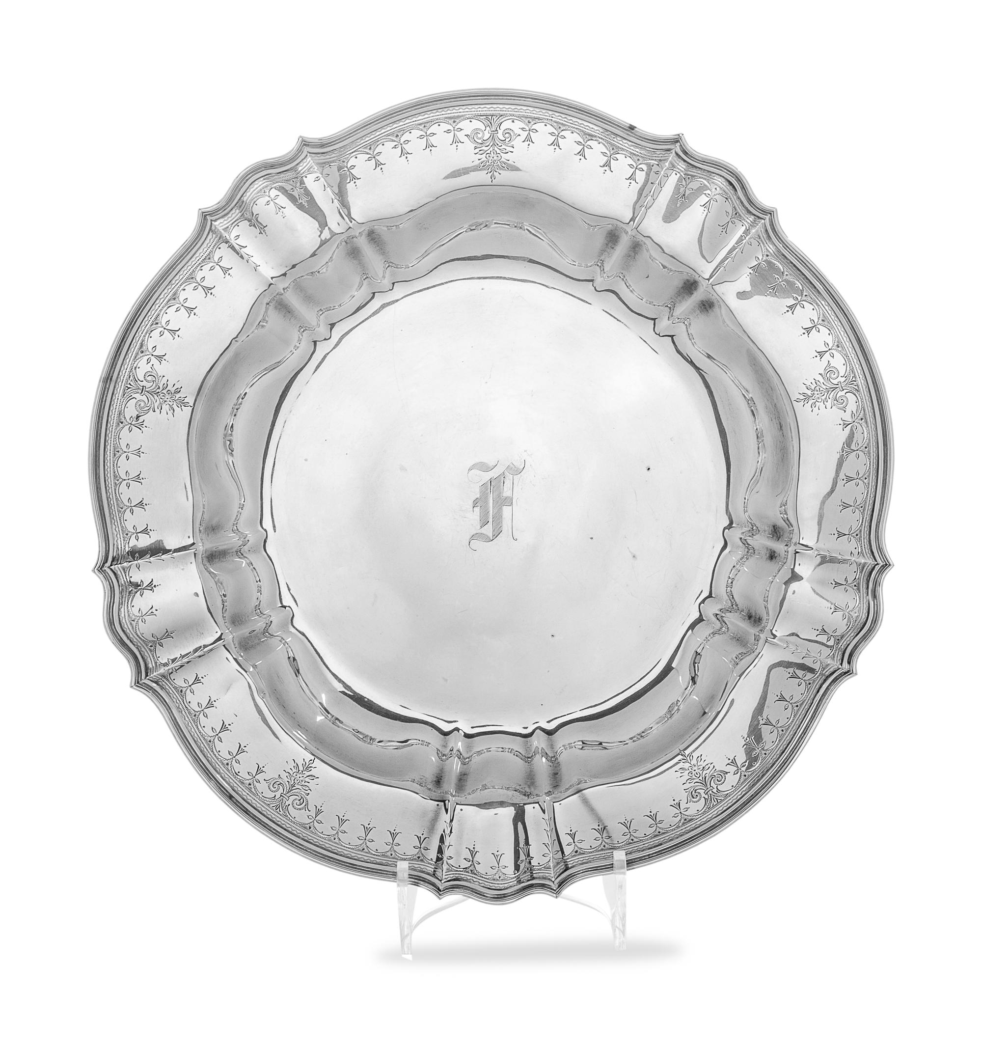 having scalloped rim with engraved decoration and center monogram.